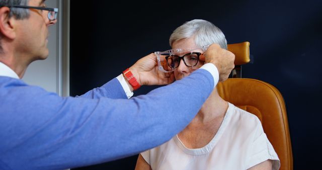 Optometrist Adjusting Glasses for Senior Woman During Eye Exam - Download Free Stock Images Pikwizard.com