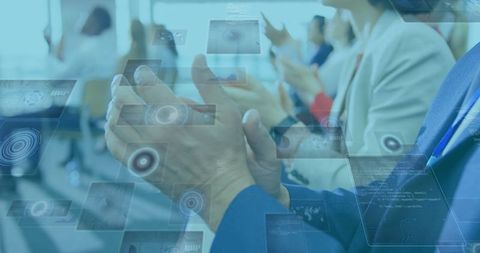 Business professionals applauding innovative technology presentation