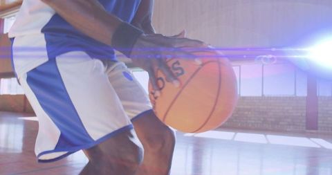Dynamic Basketball Player Dribbling in Gym Setting