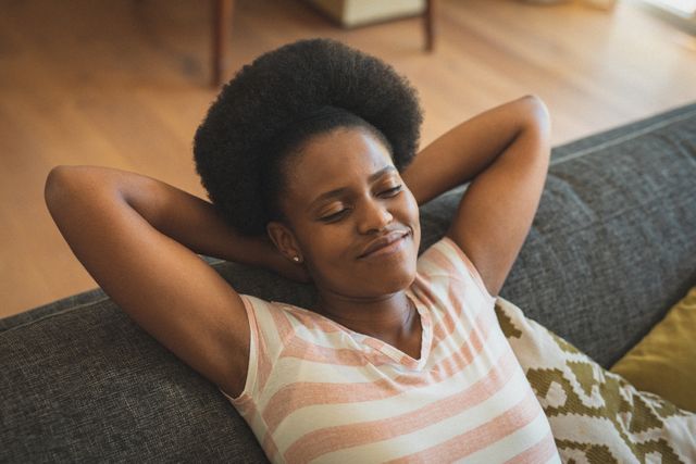 African American Woman Relaxing on Sofa with Eyes Closed - Download Free Stock Images Pikwizard.com