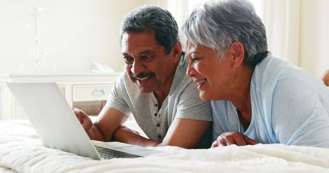 Senior Latino Couple Enjoying Technology Together at Home