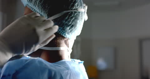Surgeon Preparing for Procedure with Mask and Gloves