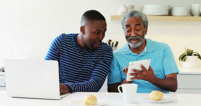 Father and Son Enjoying Breakfast and Technology at Home - Download Free Stock Images Pikwizard.com