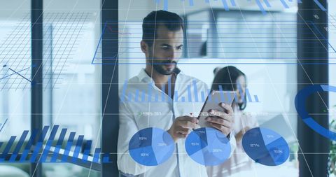 Businessman analyzing digital financial charts in modern office