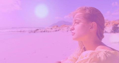 Woman in Yellow Top Relaxing on Scenic Beach with Rocky Outcrops