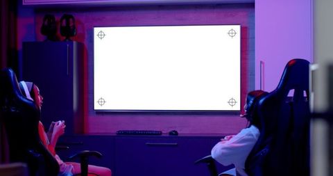 Teenagers enjoying video games in modern gaming room