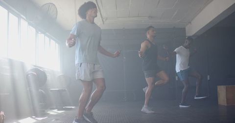 Group of Men Jump Rope in Gym for Fitness Cardio Session