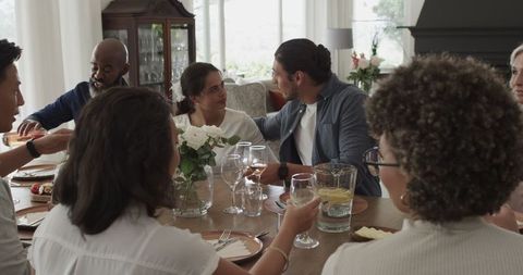 Friends Celebrating with Food and Drinks Around Table