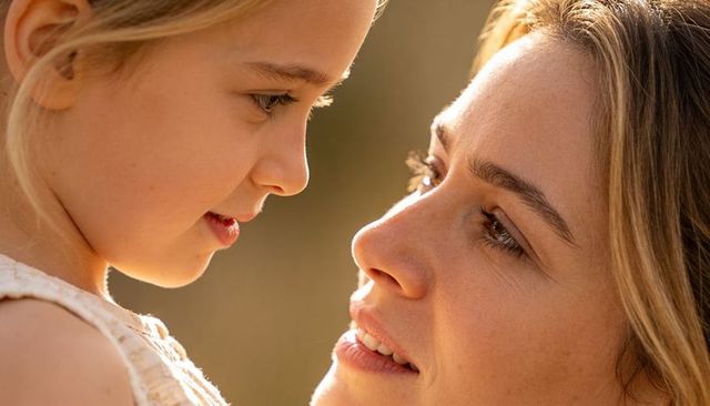 Mother and daughter gazing closely in golden hour close-up warm family bonding portrait