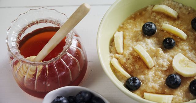 A nutritious breakfast of oatmeal with fruits and honey emphasizes healthy eating. - Download Free Stock Photos Pikwizard.com