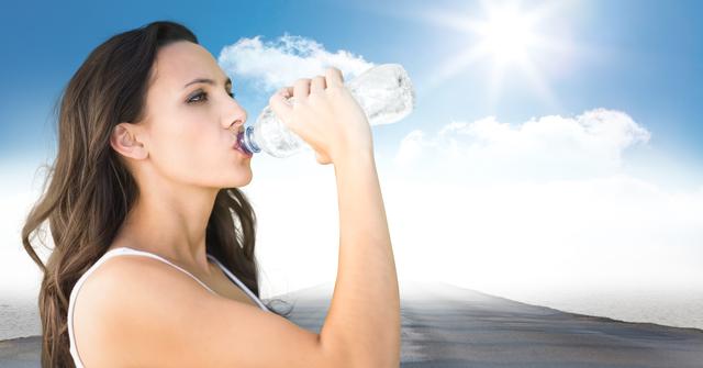Woman drinking water from bottle under bright sun with sky in background. Ideal for use in articles or advertisements about hydration, healthy living, fitness, outdoor activities, summer health tips, and skincare routines.