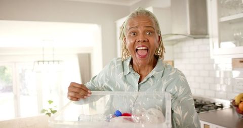 Senior Woman Enthusiastically Engaging in Home Recycling