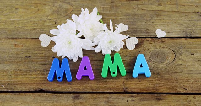Colorful Letters Spelling Mama with White Flowers on Wooden Surface - Download Free Stock Photos Pikwizard.com