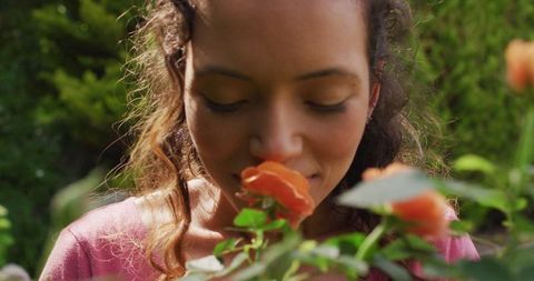 Woman Enjoying Fragrance of Blooming Roses in Lush Garden - Download Free Stock Images Pikwizard.com