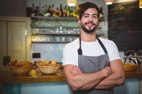 Smiling Barista in Café with Baskets of Freshly Baked Goods - Download Free Stock Images Pikwizard.com