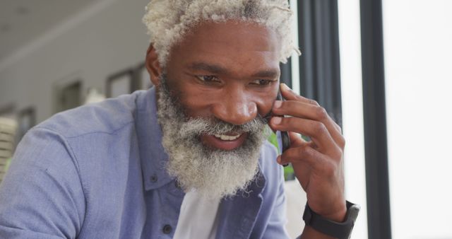 Image of african american senior man using smartphone. retirement lifestyle, spending time alone at home concept digitally generated image.