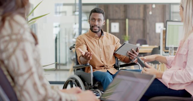 Diverse Office Team Collaborating with Disabled Colleague - Download Free Stock Images Pikwizard.com