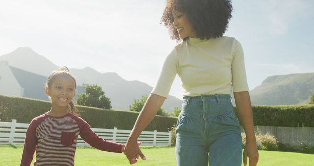 Happy Afro-American Mother and Daughter Walking Outdoors in Sunlight - Download Free Stock Images Pikwizard.com