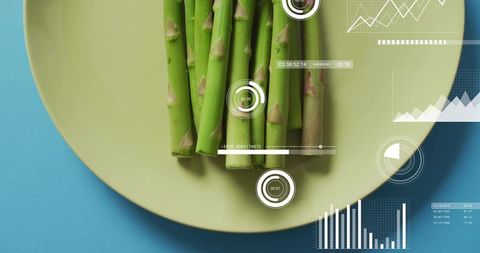 Green asparagus bundle on yellow plate with futuristic hud data visualization overlay