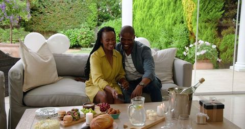 Couple enjoying outdoor brunch gathering with laughter and joy
