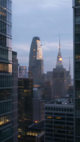 Vertical Manhattan video panning through office window toward Empire State Building at dusk