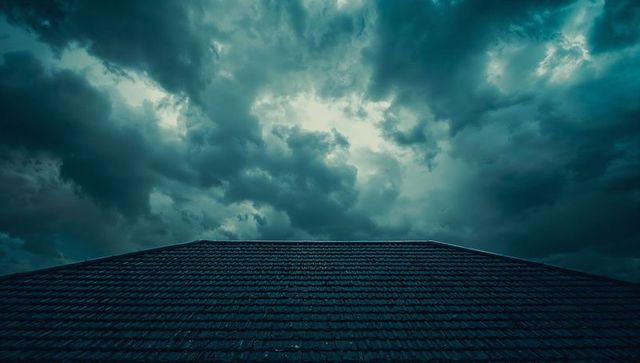 Dramatic tiled roof against stormy skies