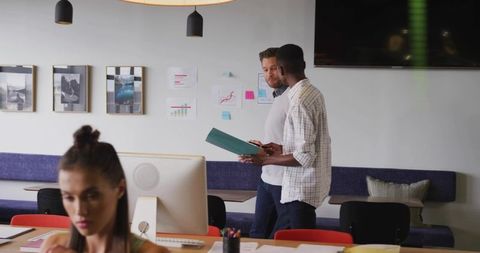 Business colleagues reviewing documents in a creative office environment