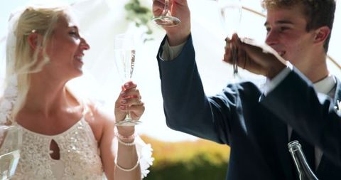 Joyful Wedding Celebration with Cheers and Smiles in Garden Setting