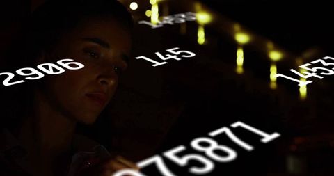 Woman interprets numeric data in futuristic control room