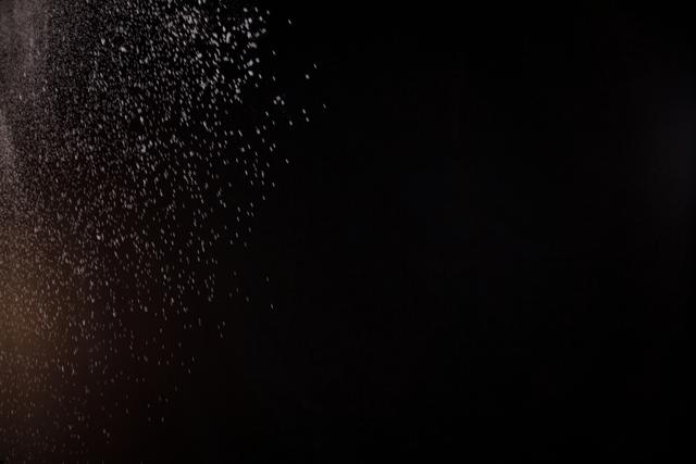 Dust Particles Floating Against Black Background - Download Free Stock Photos Pikwizard.com