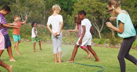 Fun Summer Play: Kids Enjoying Sprinkler on a Sunny Day - Download Free Stock Images Pikwizard.com