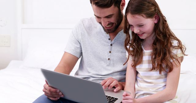 Father and Daughter Using Laptop Together on Bed - Download Free Stock Images Pikwizard.com