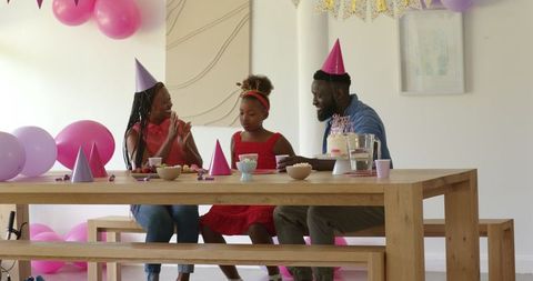Happy Family Celebrating Birthday with Cake and Decorations