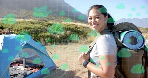 Tech-Savvy Woman Camping in Wilderness Tracks Weather Conditions