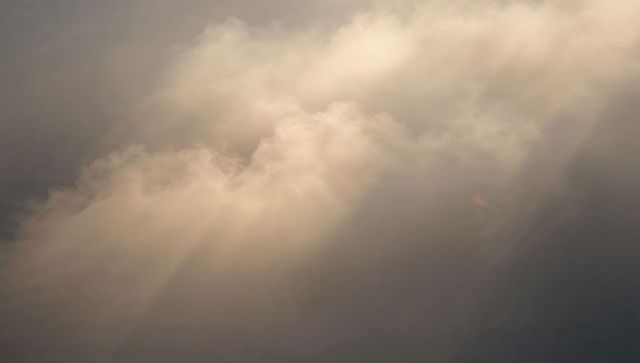 Golden Crepuscular Rays Breaking Through Billowy Cloud Bank, Warm Soft Sunrise Light