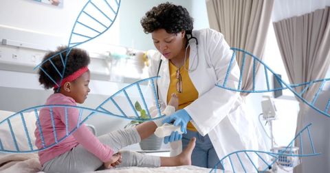 Medical professional bandaging young girl's leg with dna visualization