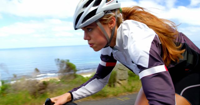 Focused Female Cyclist on Coastal Road Ride - Download Free Stock Images Pikwizard.com