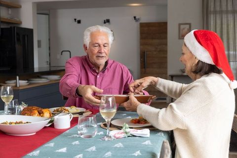 Senior Couple Enjoying Christmas Meal at Home Together