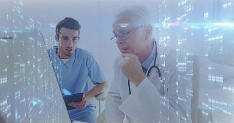 Doctors reviewing patient data on networked devices in hospital