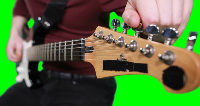 Musician tuning electric guitar close-up on green screen - Download Free Stock Images Pikwizard.com