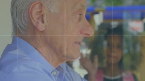 Elderly Man and Child Observing Data Visualizations