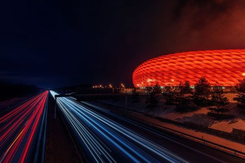 Illuminated Stadium with Vibrant Night Traffic