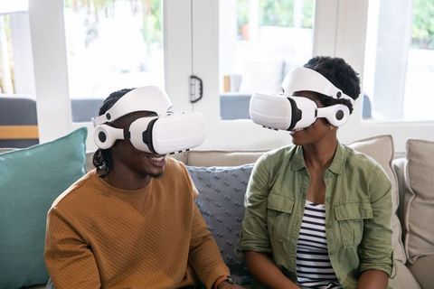 Couple Engaging in Virtual World with VR Headsets at Home