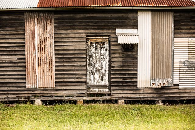 Weathered Wooden Shack with Corrugated Metal Roof and Boards - Download Free Stock Photos Pikwizard.com
