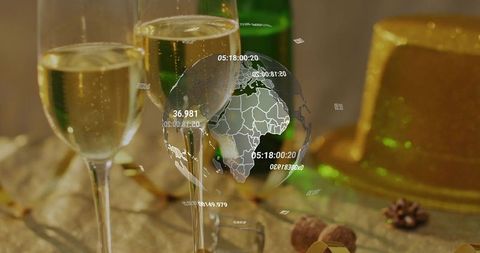Champagne flutes toasting with digital globe overlay on gold party table