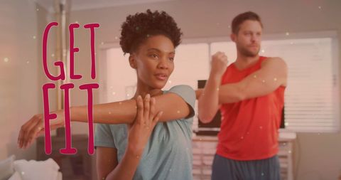 Couple stretching at home with get fit motivation text