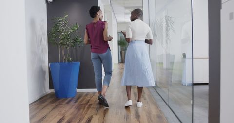 Casual Businesswomen Walking and Discussing in Modern Office - Download Free Stock Images Pikwizard.com