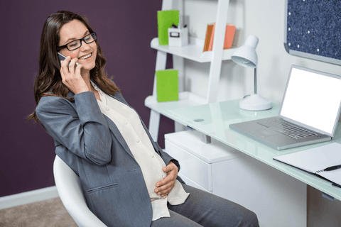 pregnant businesswoman on phone smiling in home office setting - Download Free Stock Videos Pikwizard.com