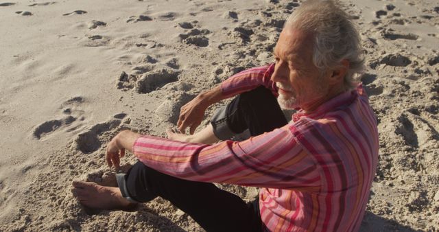 Senior Man Relaxing on Sandy Beach During Sunset - Download Free Stock Images Pikwizard.com