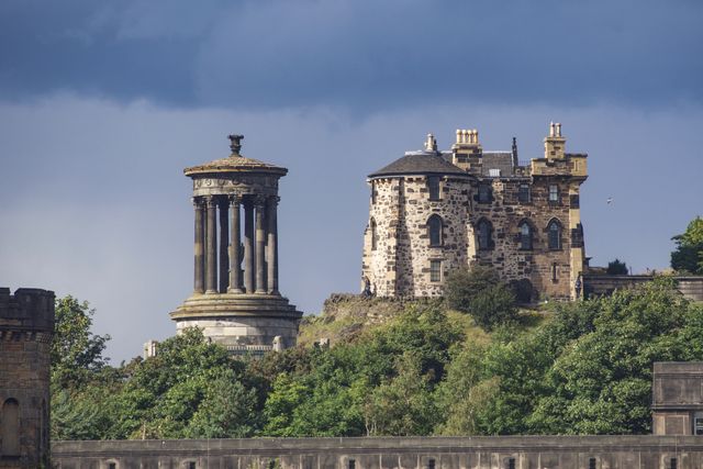 Calton Hill in Edinburgh is a famed historical site featuring the Dugald Stewart Monument, ideal for travel websites, tourism brochures, historical architecture studies, and British heritage promotions.